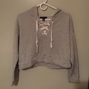 A cropped hoodie with criss cross in the front